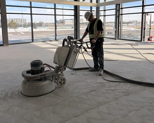 Hardscapes employee grinding concrete floors